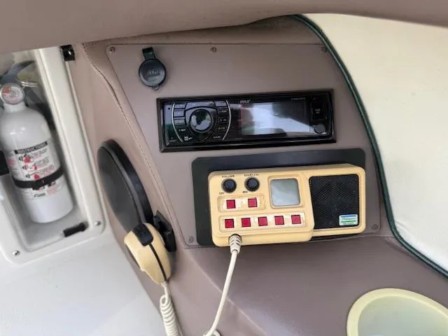 Slide: The Image of Control panel of a 1995 Cobalt 252 boat with radio and fire extinguisher. - 10