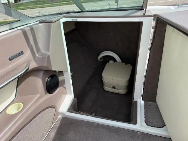 Slide: The Image of 1995 Cobalt 252 boat interior storage compartment with portable toilet. - 14