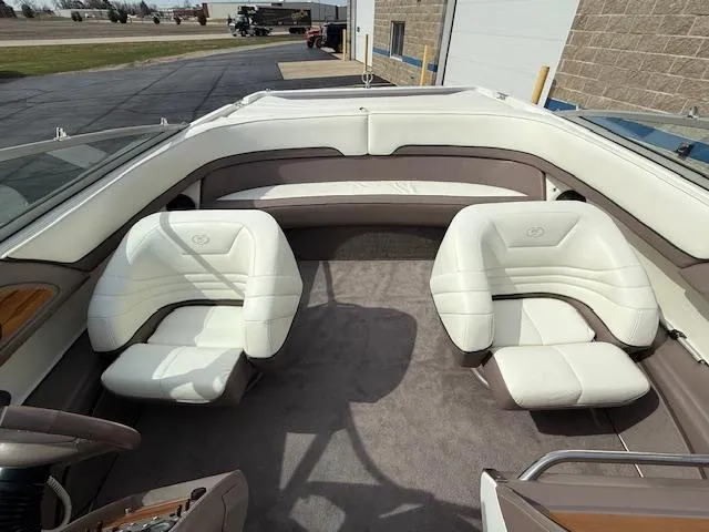 Slide: The Image of Interior of a 1995 Cobalt 252 boat with white leather seats and spacious layout. - 16