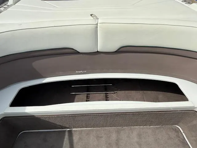 Slide: The Image of 1995 Cobalt 252 boat interior with open storage compartment and cushioned seating. - 17