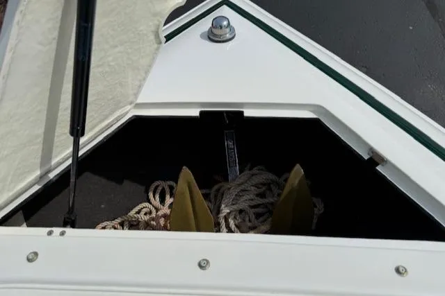 Slide: The Image of Open storage compartment on a 1995 Cobalt 252 boat with ropes inside. - 22