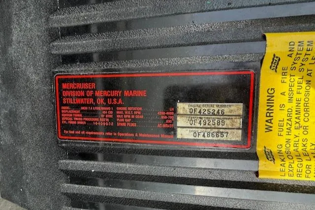 Slide: The Image of Label on a 1995 Cobalt 252 boat engine, showing MerCruiser details and warning instructions. - 27