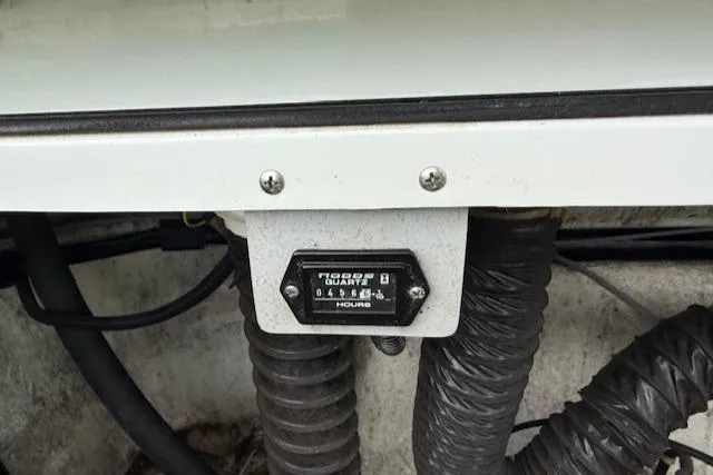 Slide: The Image of Hour meter on 1995 Cobalt 252 boat, surrounded by hoses and wiring. - 28