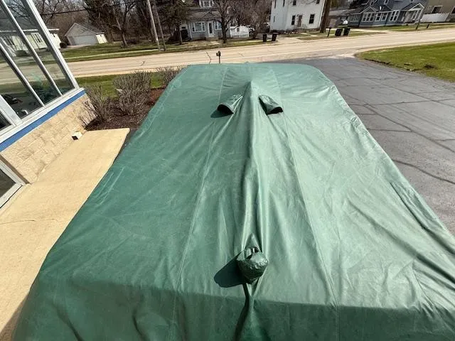 Slide: The Image of Covered 1995 Cobalt 252 boat on driveway with green tarp. - 32