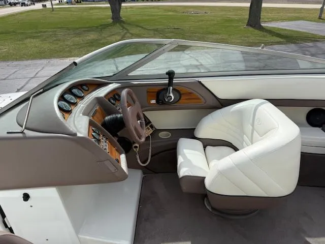 Slide: The Image of Interior of a 1995 Cobalt 252 boat with white seating and control panel. - 7