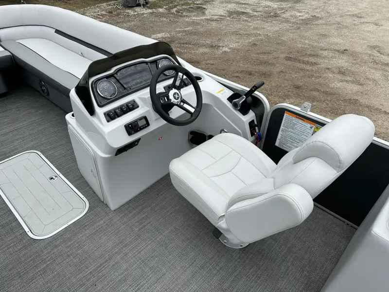 Slide: The Image of 2021 Godfrey Sweetwater 2486 SB boat interior with steering console and seating. - 13