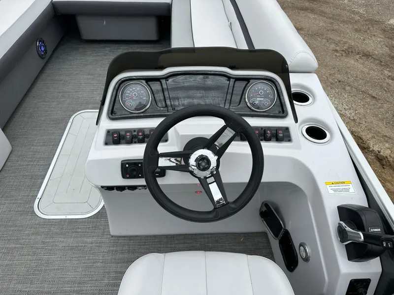 Slide: The Image of 2021 Godfrey Sweetwater 2486 SB boat dashboard with steering wheel and control panel. - 20