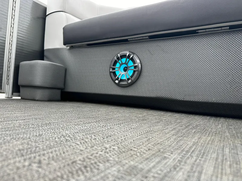 Slide: The Image of 2021 Godfrey Sweetwater 2486 SB boat interior with speaker and cushioned seating. - 25