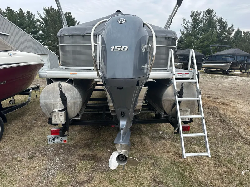 Slide: The Image of 2021 Godfrey Sweetwater 2486 SB pontoon boat with 150 HP engine, parked on grass. - 9