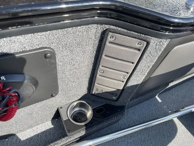 Slide: The Image of Interior detail of 2025 Lund 2075 Pro-V Sport boat, featuring cup holder and panel. - 28
