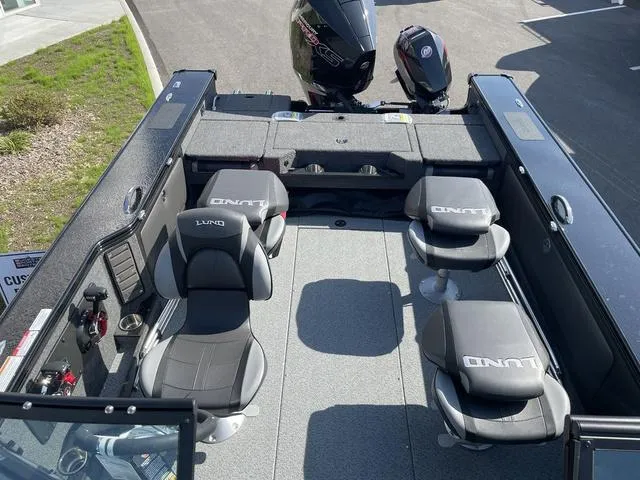 Slide: The Image of 2025 Lund 2075 Pro-V Sport boat interior with seating and motor, viewed from above. - 6