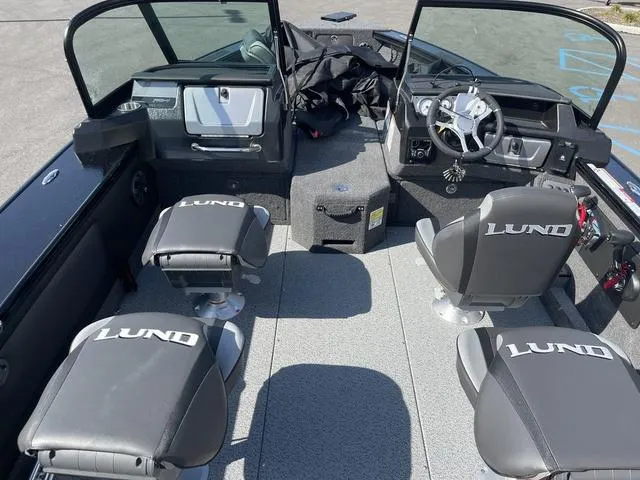 Slide: The Image of 2025 Lund 2075 Pro-V Sport boat interior with four seats and steering console. - 7