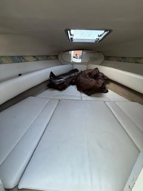 Slide: The Image of Interior cabin of 1999 Chaparral 2135 SS boat with white seating and skylight. - 11
