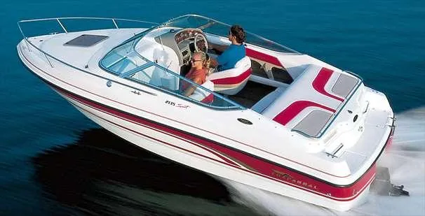 Slide: The Image of 1999 Chaparral 2135 SS boat cruising on water, featuring sleek design and red accents. - 13