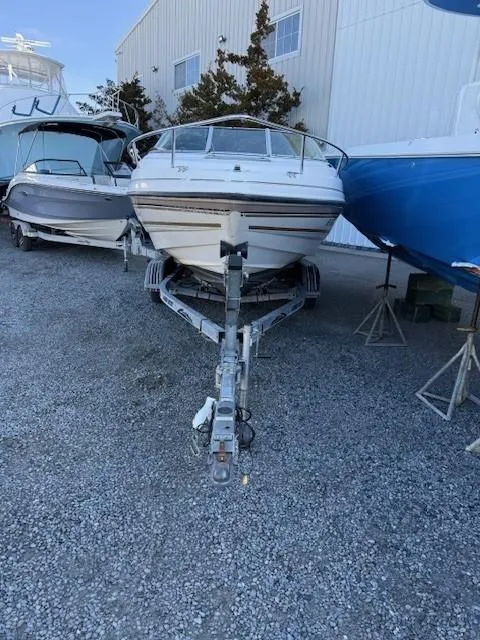 Slide: The Image of 1999 Chaparral 2135 SS boat on trailer, parked outdoors near other boats. - 5