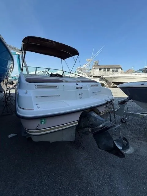 Slide: The Image of 1999 Chaparral 2135 SS boat with canopy, docked in a marina. - 6