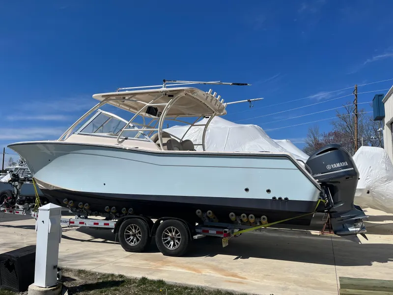 Slide: The Image of 2013 Grady-White Freedom 307 boat on trailer, clear sky background. - 0