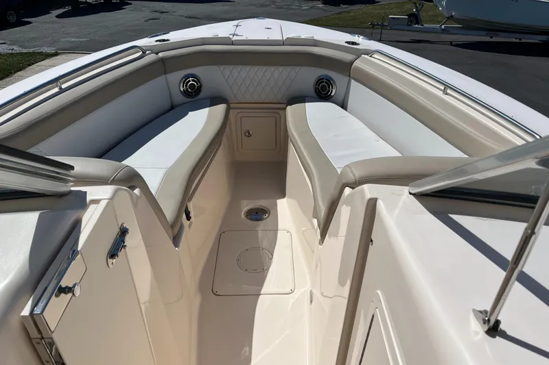 Slide: The Image of 2013 Grady-White Freedom 307 boat interior with cushioned seating and storage. - 12