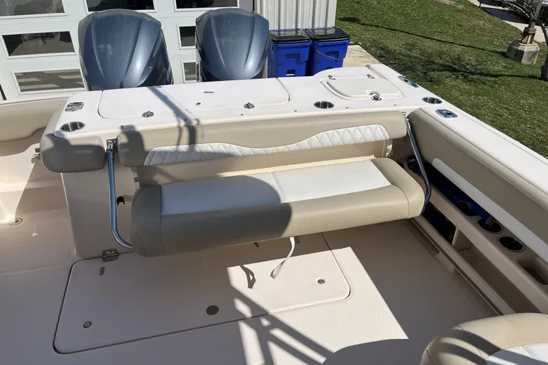 Slide: The Image of 2013 Grady-White Freedom 307 boat interior with seating and dual engines. - 17