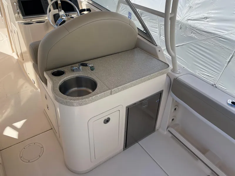Slide: The Image of 2013 Grady-White Freedom 307 boat interior with sink and storage area. - 21