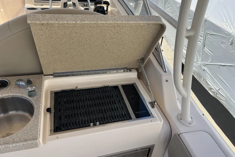 Slide: The Image of 2013 Grady-White Freedom 307 boat with built-in grill and sink on deck. - 22