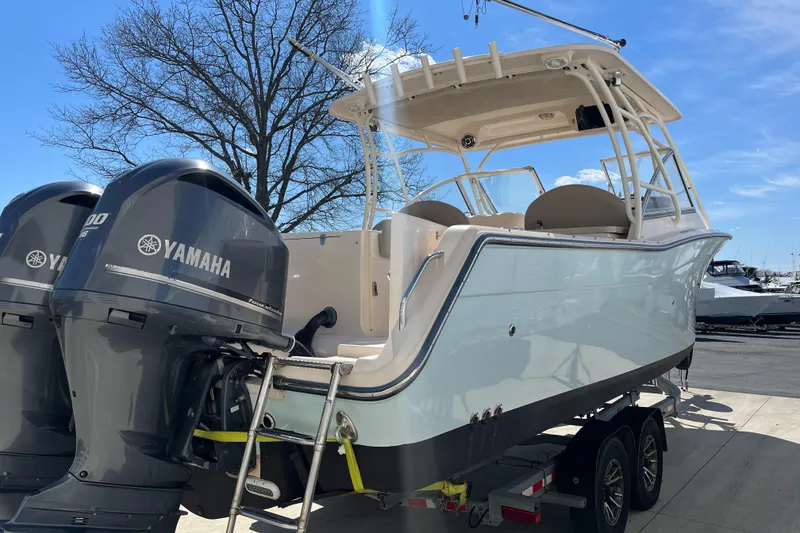 Slide: The Image of 2013 Grady-White Freedom 307 boat with dual Yamaha engines on a trailer. - 3