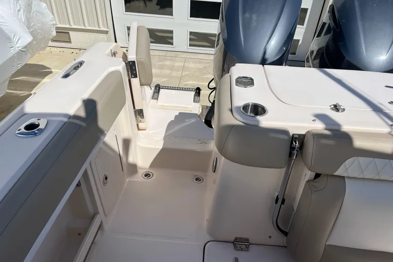 Slide: The Image of 2013 Grady-White Freedom 307 boat interior with seating and cup holders. - 30