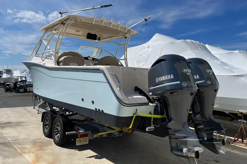 Slide: The Image of 2013 Grady-White Freedom 307 boat with twin Yamaha 300 engines on a trailer. - 4