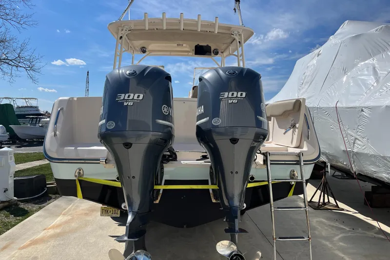 Slide: The Image of 2013 Grady-White Freedom 307 boat with twin 300 V6 engines, docked outdoors. - 6