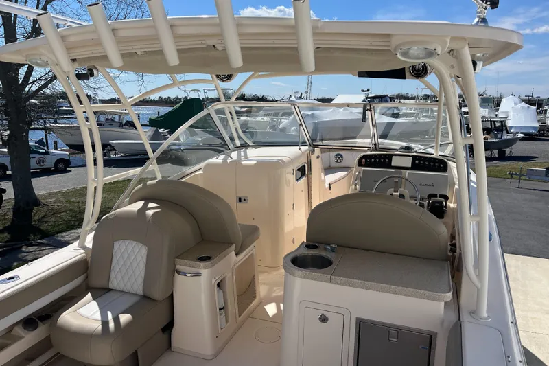 Slide: The Image of 2013 Grady-White Freedom 307 boat interior with seating and helm station. - 7