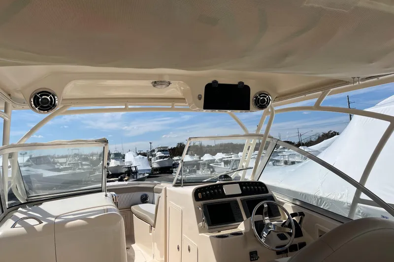 Slide: The Image of Interior view of 2013 Grady-White Freedom 307 boat with steering wheel and dashboard. - 8