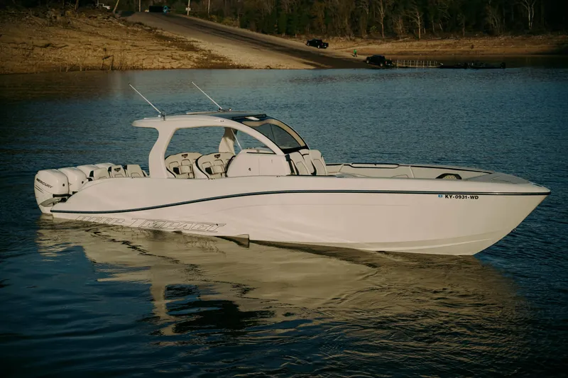 Slide: The Image of 2021 Deep Impact 399 Sport boat on calm water, showcasing sleek design and powerful engines. - 0