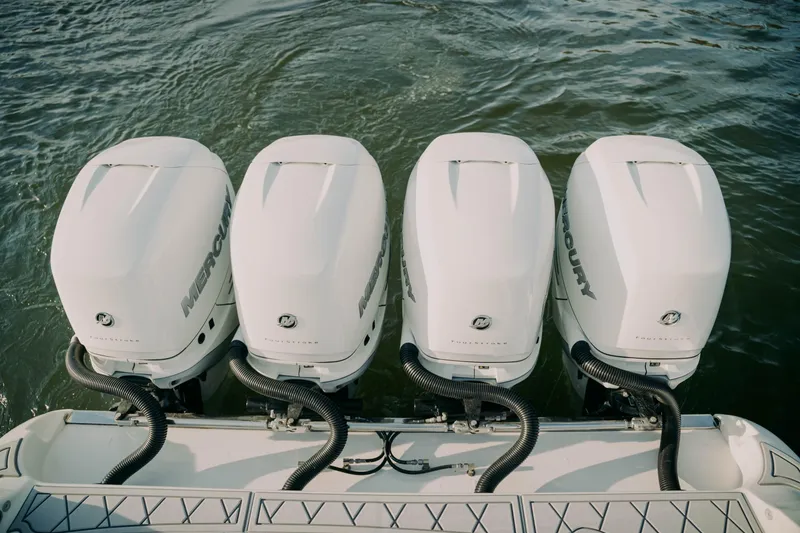 Slide: The Image of Four Mercury outboard engines on a 2021 Deep Impact 399 Sport boat. - 14