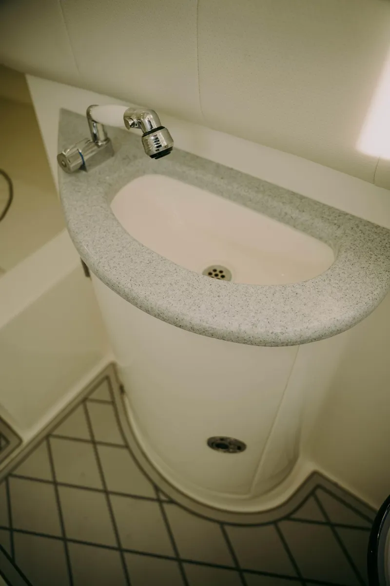 Slide: The Image of Compact sink in a 2021 Deep Impact 399 Sport boat bathroom. - 18