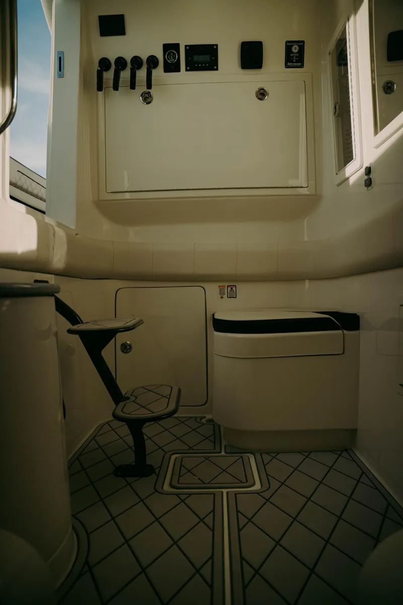 Slide: The Image of Interior of 2021 Deep Impact 399 Sport boat, featuring control panel and seating. - 19