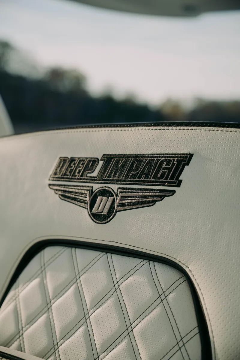 Slide: The Image of 2021 Deep Impact 399 Sport interior with embroidered logo on quilted leather seat. - 21