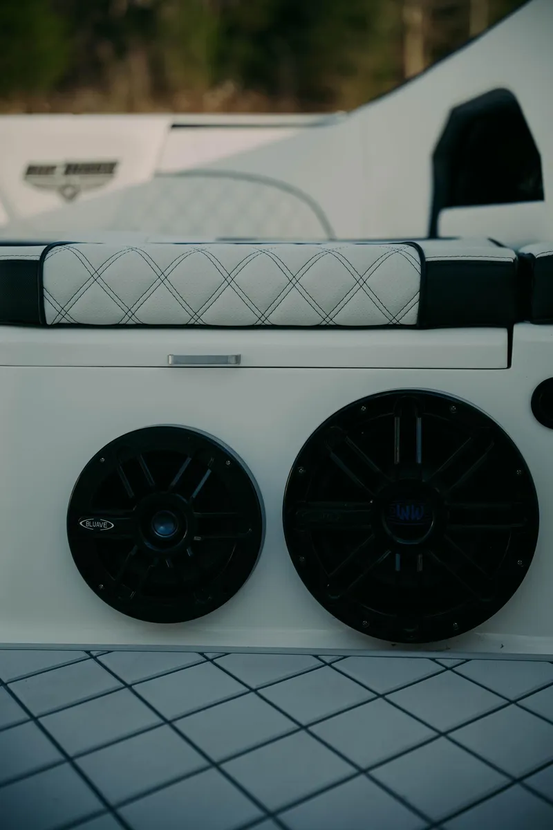 Slide: The Image of 2021 Deep Impact 399 Sport boat interior with speakers and quilted seating. - 22