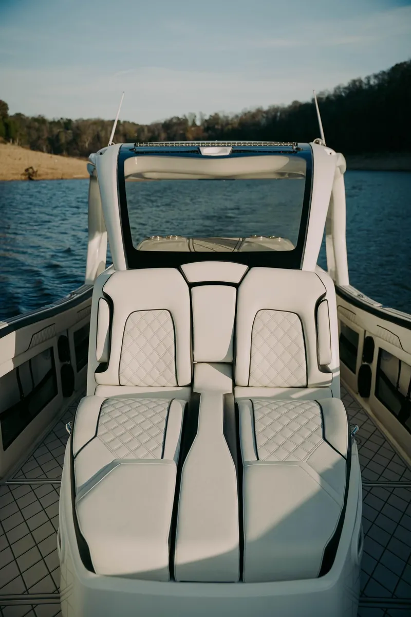 Slide: The Image of Luxury 2021 Deep Impact 399 Sport boat interior on a serene lake. - 3