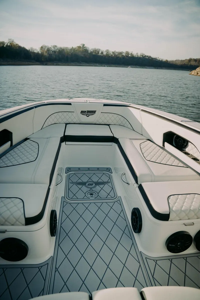 Slide: The Image of 2021 Deep Impact 399 Sport boat interior with luxurious seating on a calm lake. - 4