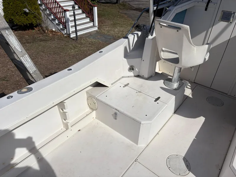 Slide: The Image of 1988 Grady-White 22 Seafarer boat interior with white seating and storage compartment. - 11