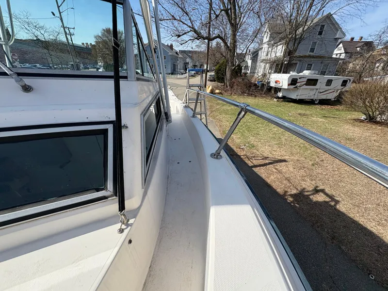 Slide: The Image of 1988 Grady-White 22 Seafarer boat docked near residential area with trees and trailer. - 14