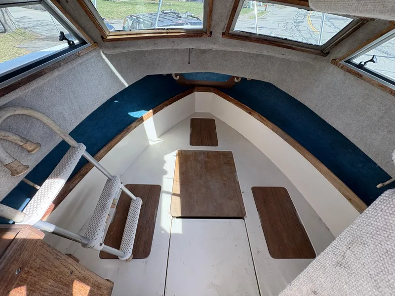 Slide: The Image of 1988 Grady-White 22 Seafarer boat interior with wooden flooring and blue accents. - 16