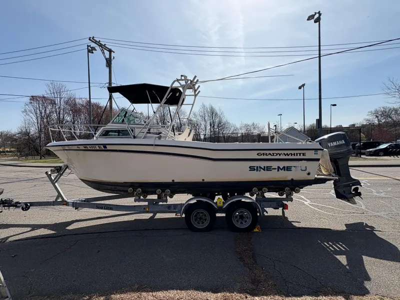 Slide: The Image of 1988 Grady-White 22 Seafarer boat on trailer, parked outdoors with Yamaha outboard motor. - 4