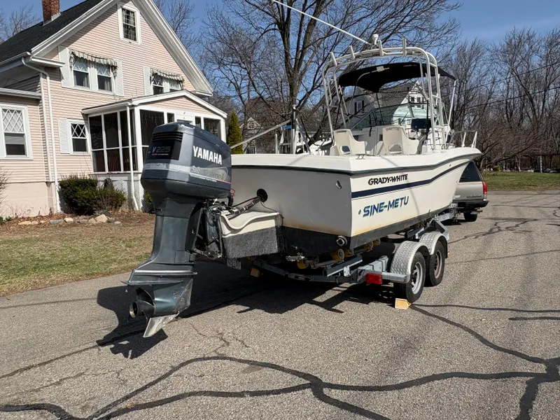 Slide: The Image of 1988 Grady-White 22 Seafarer boat on trailer, parked near a house. - 6