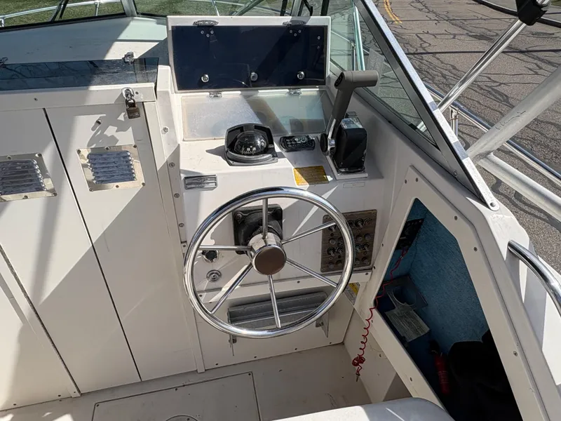Slide: The Image of 1988 Grady-White 22 Seafarer boat helm with steering wheel and navigation instruments. - 9