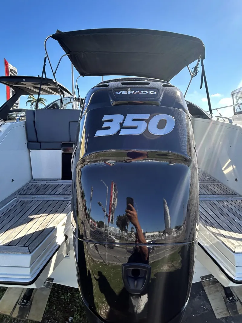 Slide: The Image of Parker Poland 850 Voyager 2022 with powerful 350 Verado engine, docked under clear blue sky. - 14