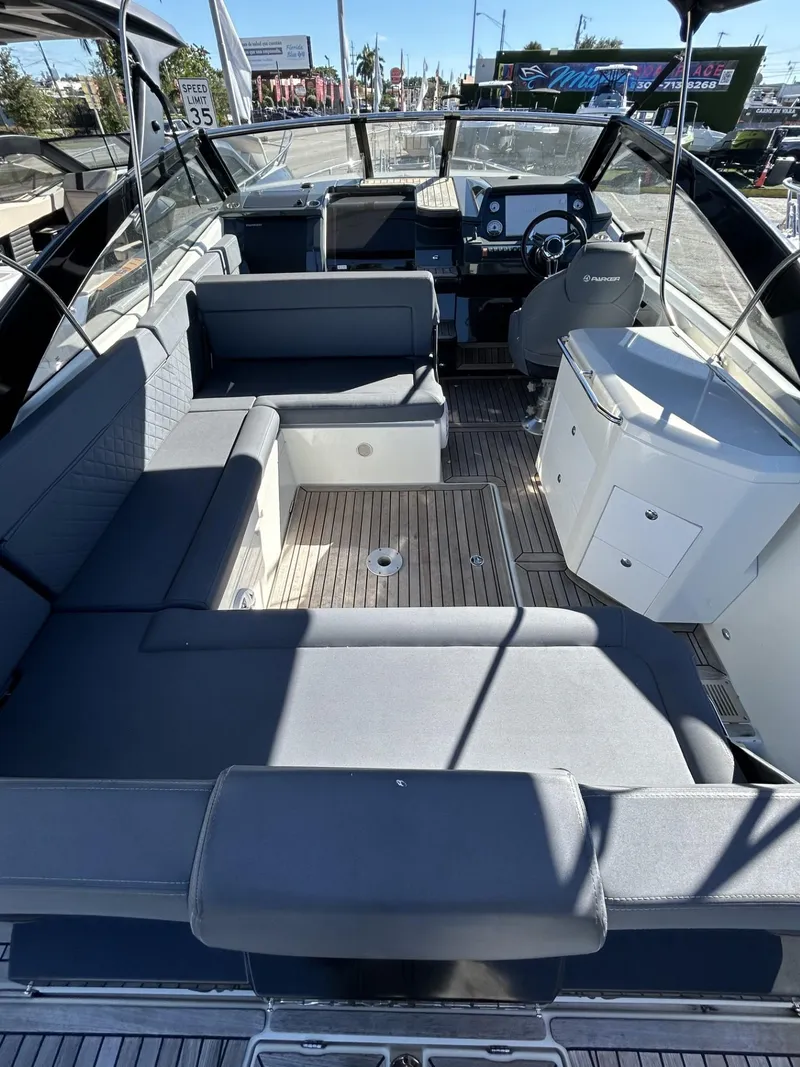 Slide: The Image of 2022 Parker Poland 850 Voyager boat interior with seating and helm, featuring modern design. - 15