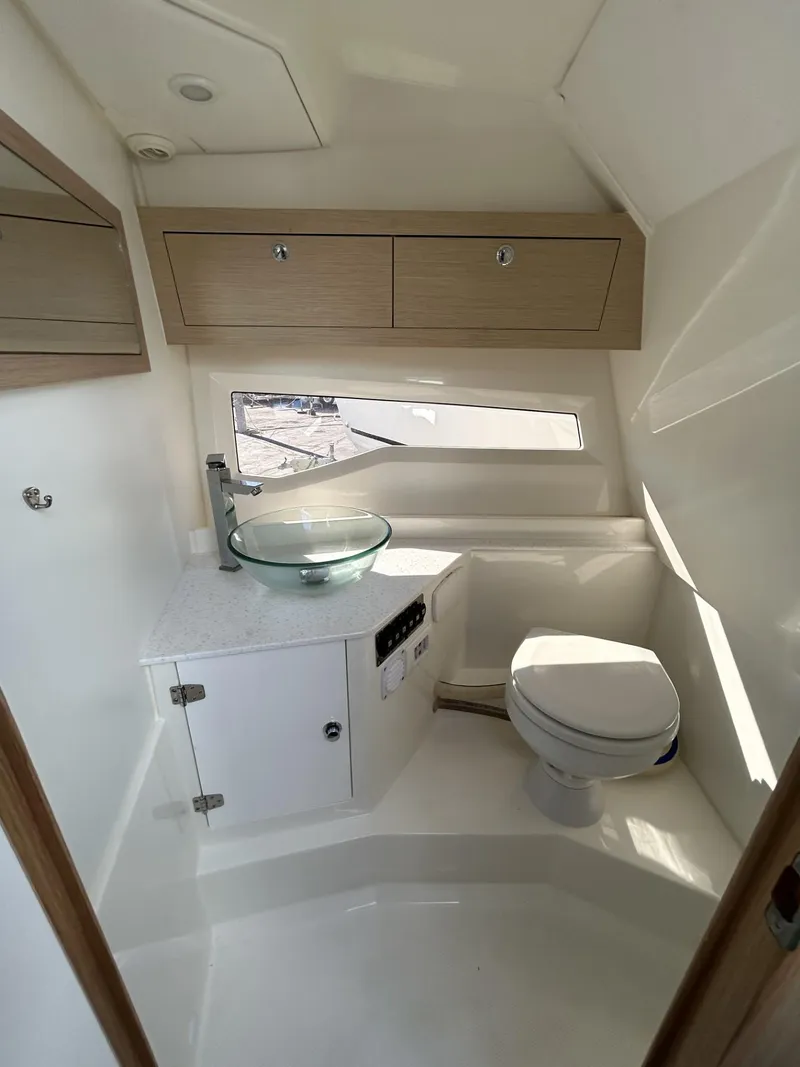 Slide: The Image of 2022 Parker Poland 850 Voyager boat bathroom with modern fixtures and wooden cabinets. - 19
