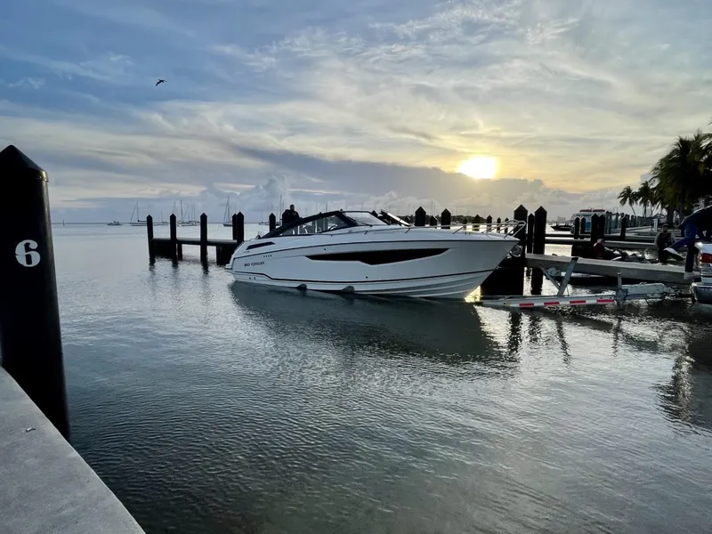 Slide: The Image of 2022 Parker Poland 850 Voyager boat docked at sunset, calm waters, scenic view. - 2
