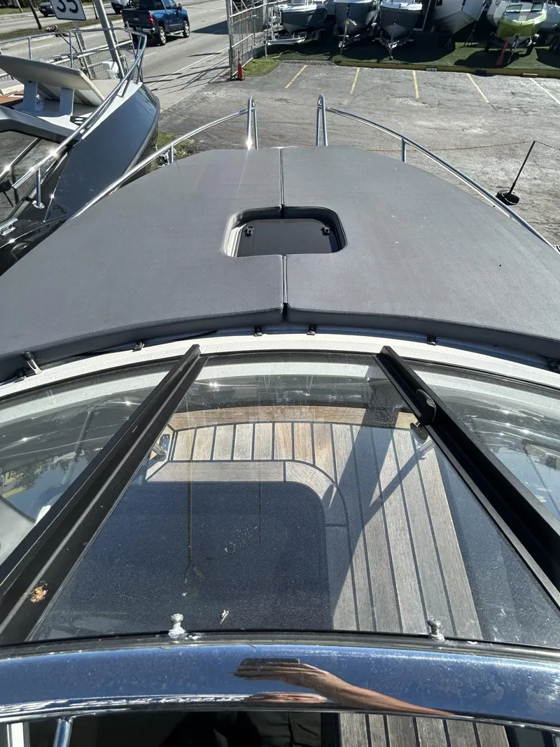 Slide: The Image of 2022 Parker Poland 850 Voyager boat deck with sunroof and sleek design. - 20